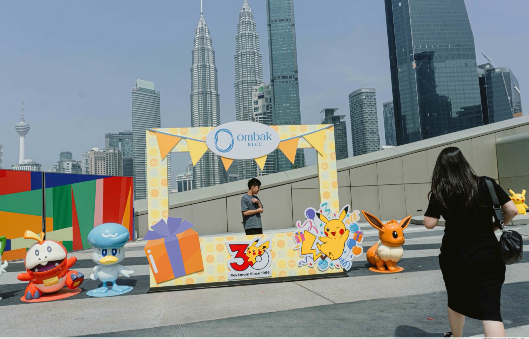 Pokémon 30th Anniversary photo frame on Ombak KLCC rooftop Sky Garden with the PETRONAS Twin Towers behind